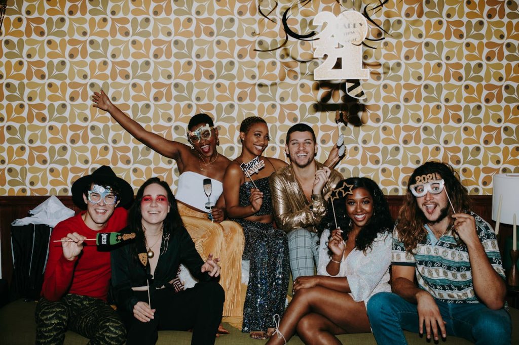 A diverse group enjoying a vibrant New Years Eve party with cheerful decorations.